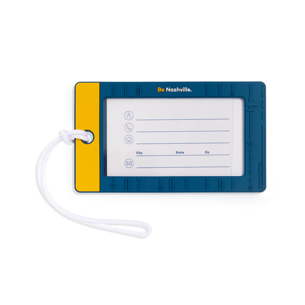 Window slot for your information on blue and yellow silicone luggage tag.  Features "Be Nashville." tagline above the window.