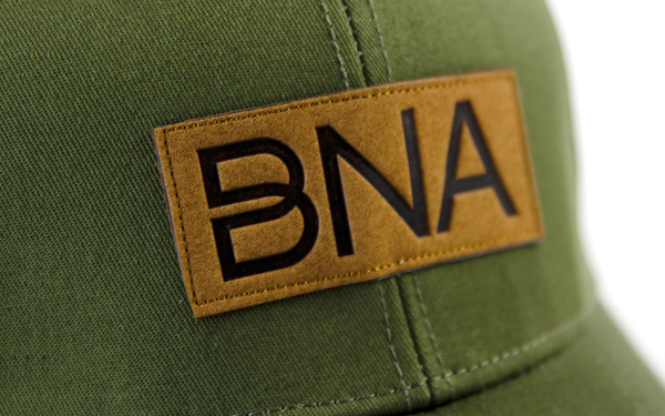 Detail view of BNA Logo patch on Olive BNA Patch Trucker Hat