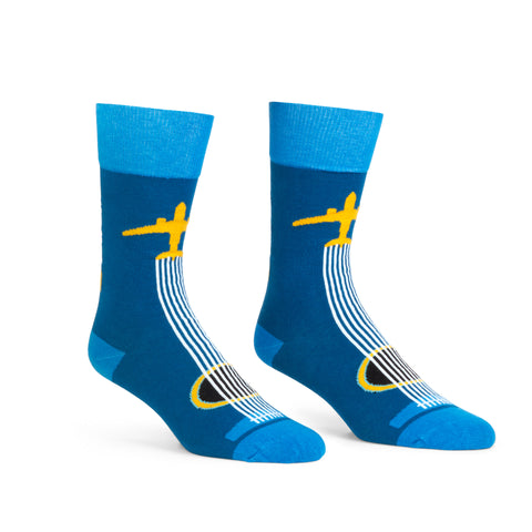 Side view of BNA Airplane Socks, which are a dark blue base with airplane guitar design (6 strings of guitar coming from tail of the plane) and bright blue cuffs, heels, and toes.