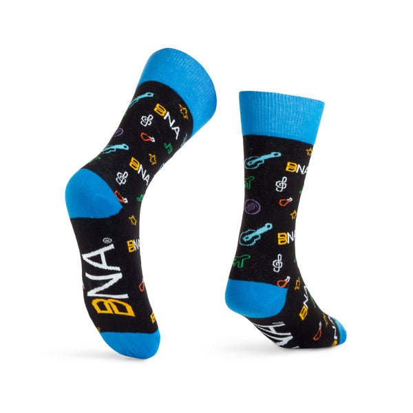 Black cuffs with BNA & Nashville pattern allover design.  Bright blue cuffs, heels, and toes.  Pattern features planes, BNA logo, music notes, hot chicken, stars, and guitars.  BNA logo on the sole.
