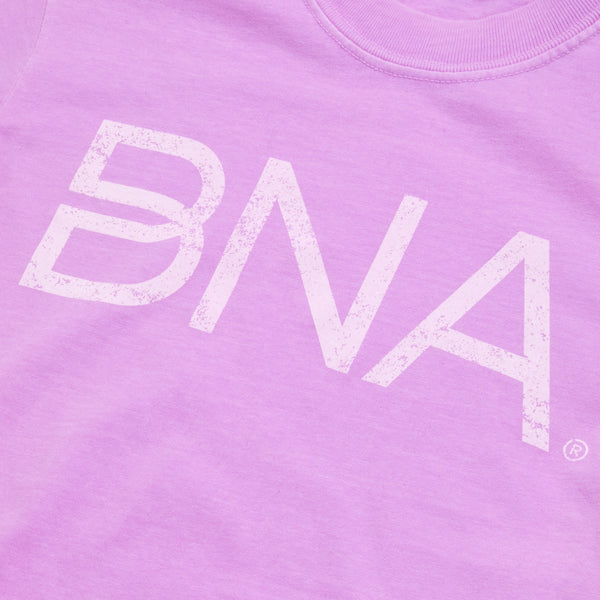 Close-up of neon violet crewneck t-shirt with white distressed BNA logo centered on the chest.  BNA logo features a unique infinity "B."