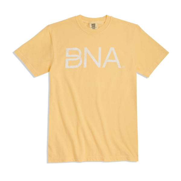 Light yellow crewneck t-shirt with white distressed BNA logo centered on the chest.  BNA logo features a unique infinity "B."