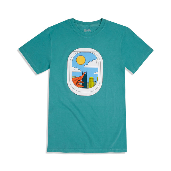 Seafoam teal t-shirt with center front graphic depicting an illustrated view of a window seat and the view outside with sun, clouds, and Nashville's skyline.  The wing of a plane with BNA painted completes the picture.