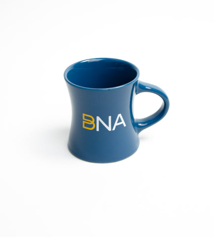 Blue BNA Logo Coffee Mug.  Logo is a yellow infinity B with white NA.  Mug is a curved, hour-glass shaped vintage cafe style with handle.  