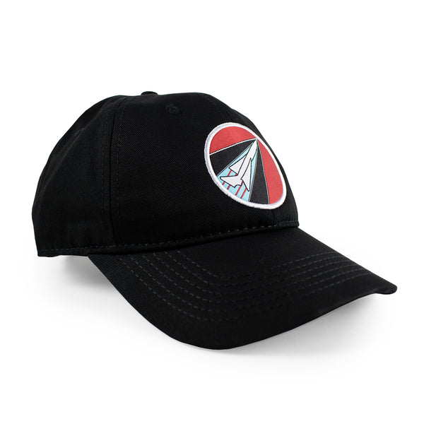 Side view of black ball cap with woven logo patch at front.  Patch features red, black, and light blue background and white outline of plane.