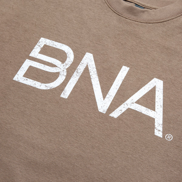 Detail shot of distressed white BNA logo on taupe colored crewneck sweatshirt