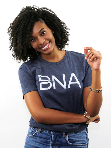 Female model wearing Heather Navy BNA Logo Tee.