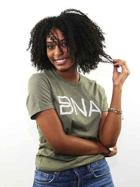 Female model wearing Heather Olive BNA Logo Tee.